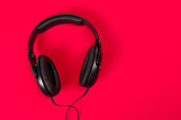 headphones on red surface