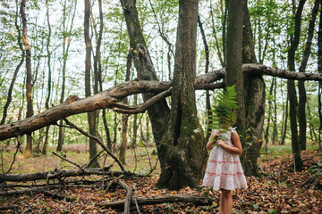 little girl in the forest with ferns
