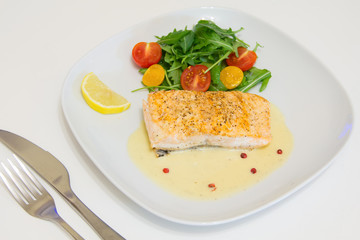 Grilled salmon steak with beurre blanc sauce, selective focus