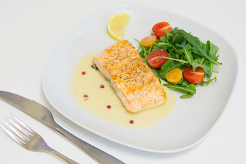 Grilled salmon steak with beurre blanc sauce, selective focus