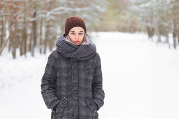 girl in the winter woods on a snowy road