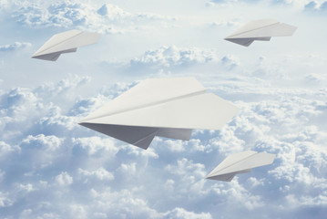Fototapeta na wymiar four Paper plane flying in blue sky