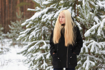 girl in a snowy winter forest. slum