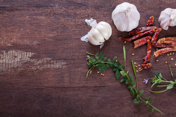 spice herb garlic chilli on old wooden background