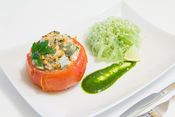 Stuffed tomatoes with salmon and shrimps, with funchoza and arugula sauce, selective focus