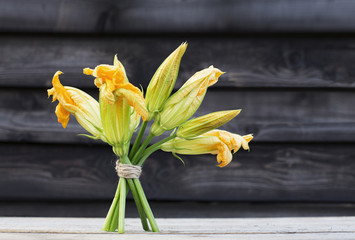 Zucchini flowers on a wooden rustic background