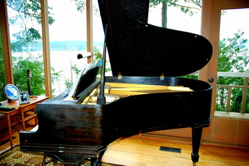 Baby grand piano inside a luxury home.