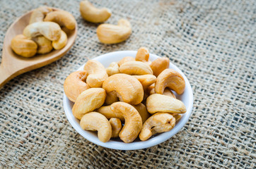 cashew nuts salted and roasted in white bowl place on hemp