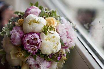 Wedding rings on a wedding bouquet.