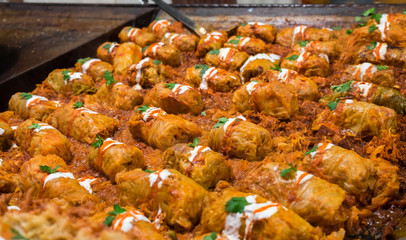 Stuffed cabbage rolls with sour cream for sale at christmas trad