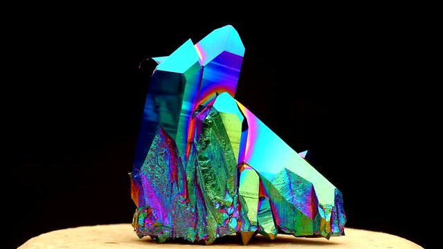 Footage of very sharp and detailed Titanium rainbow aura quartz crystal cluster stone on rotating platform with amazing light reflections effects (60fps)