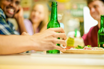 Happy friends toasting beer in bar pub restaurant 