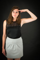 Fototapeta premium Beautiful woman doing different expressions in different sets of clothes: at attention