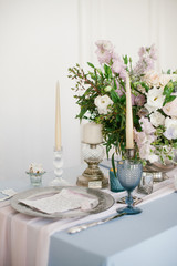 Silver candlestick and other elements of festive table wedding centerpieces decorations.