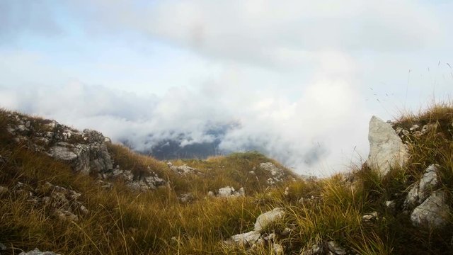 motion along the rocky terrain in autumn misty mountains