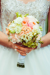 beautiful and delicate wedding bouquet in bride's hands
