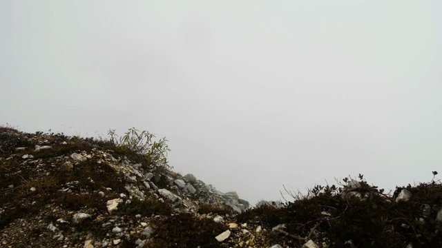motion along the rocky terrain in autumn misty mountains