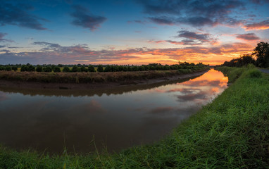 Fototapeta na wymiar sunrise reflection in a canal