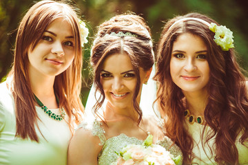 young and beautiful bride with her bridesmaids standing together