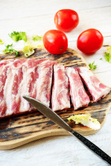 raw pork ribs on a cutting board