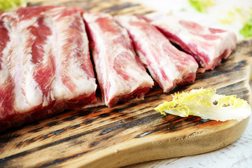 raw pork ribs on a cutting board