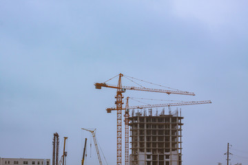 close up picture of building in progress with tower cranes