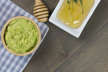 Avocado dip or guacamole with honey on wood table with free text space