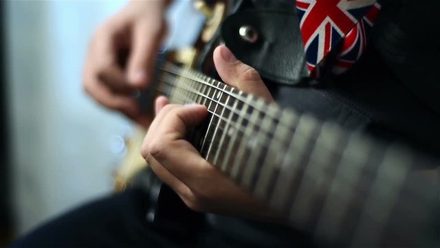 Guitarists Hands Playing On Electric Guitar. Close Up