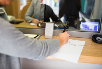 customer writing application at bank office - obrazy, fototapety, plakaty