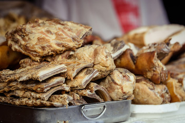 Smoked pork ribs, loin, salted bacon and lard on an vintage looking tray. Rustic and traditional style. Selective focus.