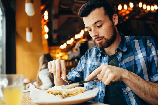 Handsome Young Man Having Lunch In Elegant Restaurant Alone