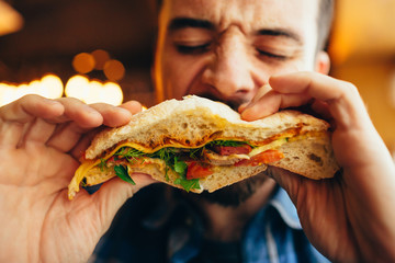 Man in a restaurant eating a hamburger