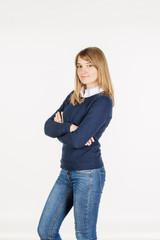 portrait of young student woman with crossed arms on gray background