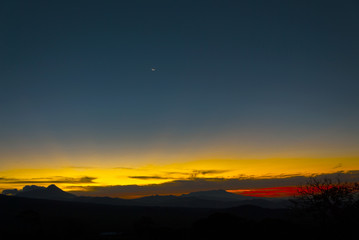 Moonrise over the rugged mountains and volcano in Guatemala