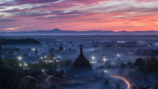 Sunset over pagodas of Mrauk-U in the mist at the northern Rakhi