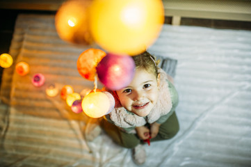 Little girl decorating home for Christmas