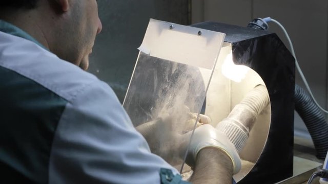 Close-up of ceramet implant creature process at laboratory. Technician creating a model of jaw with gipsum for create ceramet implant.