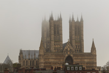 Tight view of Lincoln Cathedral in the fog, England.