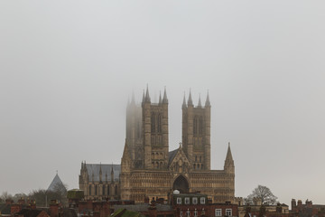 Fototapeta na wymiar High view of Lincoln Cathedral from castle wall, in fog.
