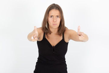 Fototapeta premium Beautiful woman doing different expressions in different sets of clothes: gun sign