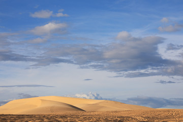 Landscape of sand dunes and clouds