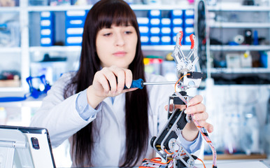 girl in robotics class research electronic device. Details of the machine with stepper motor