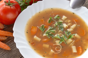 Minestrone soup in plate on wooden table