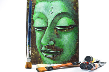 The brushes painting, color tubes and green Buddha's head picture
