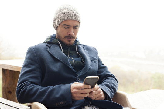 Handsome hipster modern man using smart phone