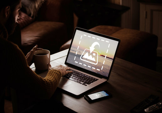 User with Laptop in Dark Room Mockup