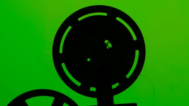 Cassette projector film rotates in frame. Studio green screen