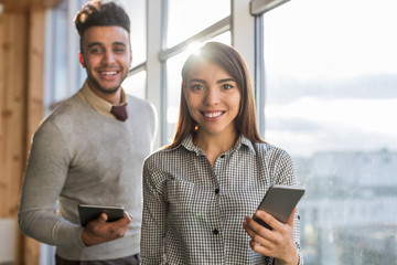 Mix Race Business Man Woman Using Cell Smart Phone Stand in front Panoramic Window Happy Smiling Businesspeople In Coworking Center Office Interior