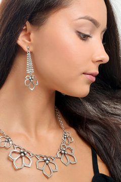 necklace and earring on young woman. Beautiful model with perfec