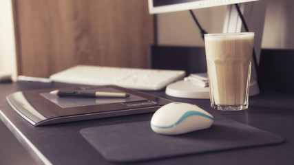 Empty workspace of a designer with graphic tablet and pen, keybo
